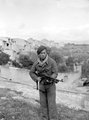 Stanley Vernon in uniform holding a gun